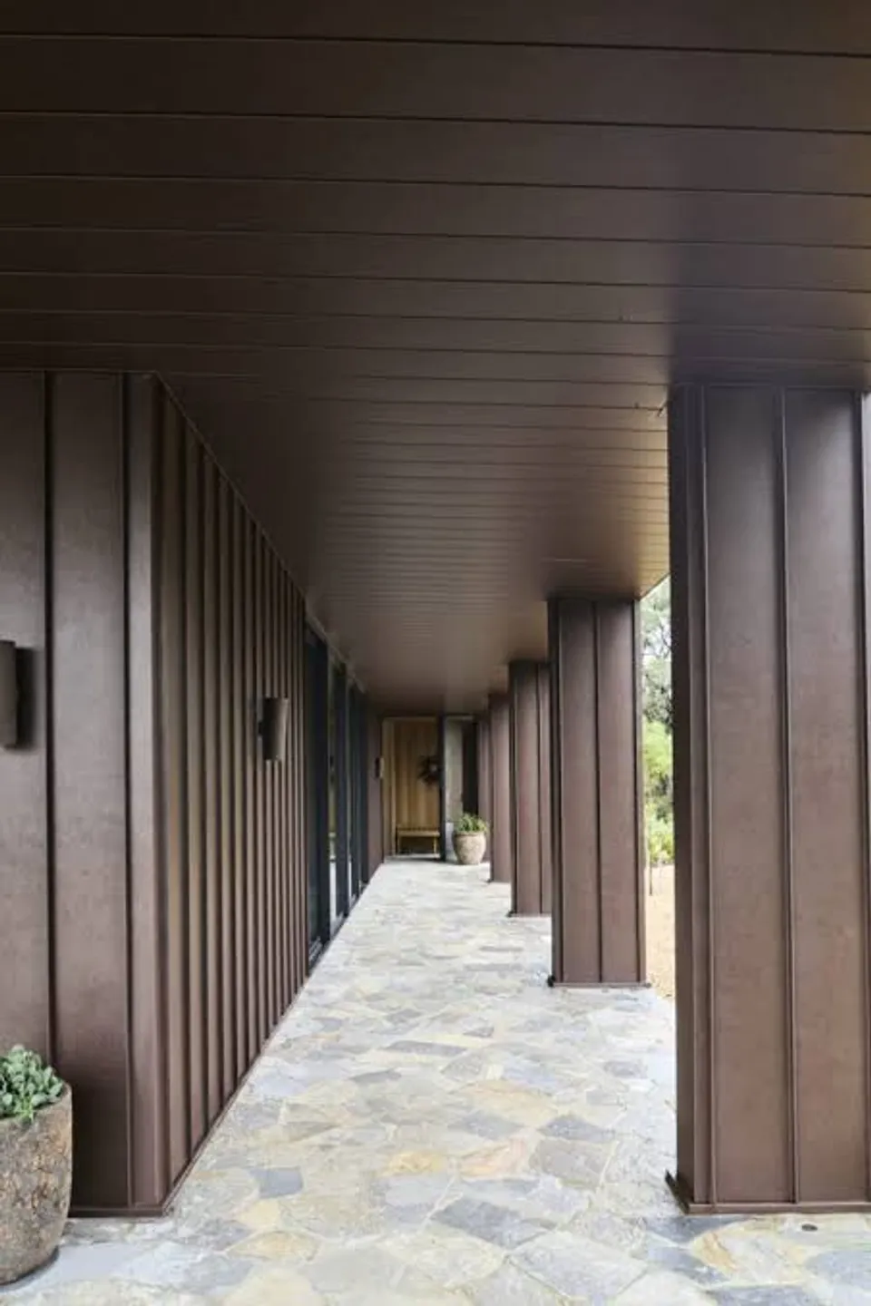Bronze board and batten metal cladding